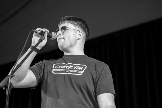 Performer on stage under spotlight
